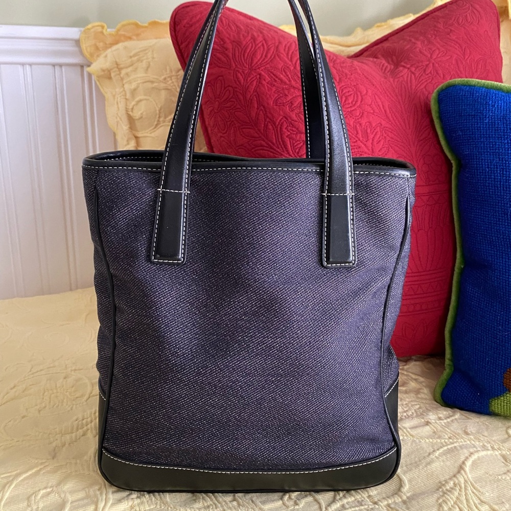 Coach denim and black bucket purse with two inside zippered pockets.